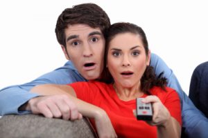 Couple staring at the screen in disbelief